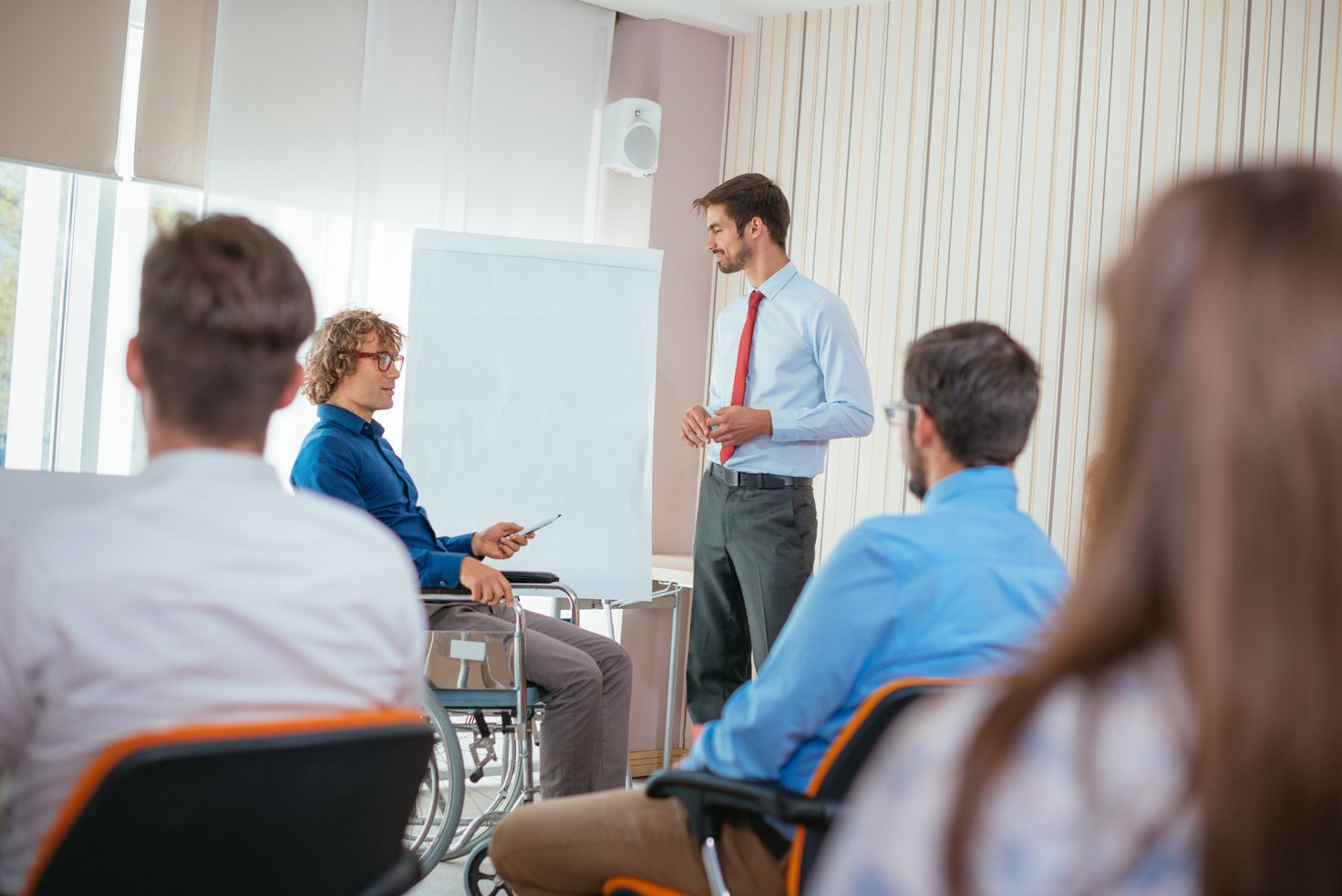 Handicapped PhD student and professor assistant in lecture hall
